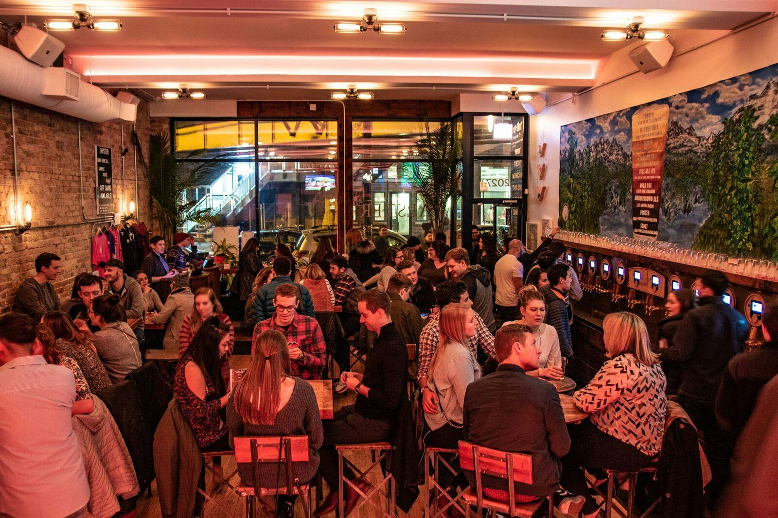 People chatting and drinking at a bar.